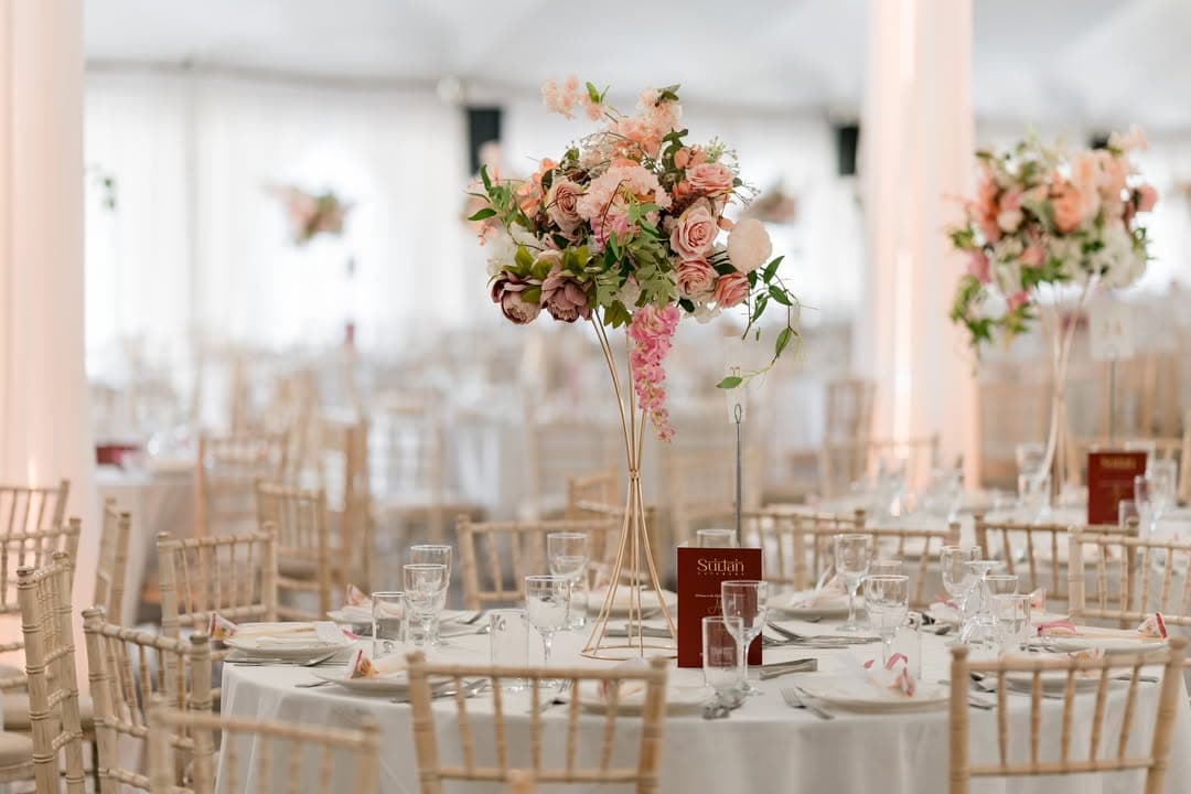 A wedding reception laid out under the marquee's sweeping canopy