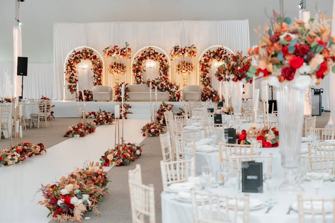 Round tables dressed in ivory beneath the marquee canopy