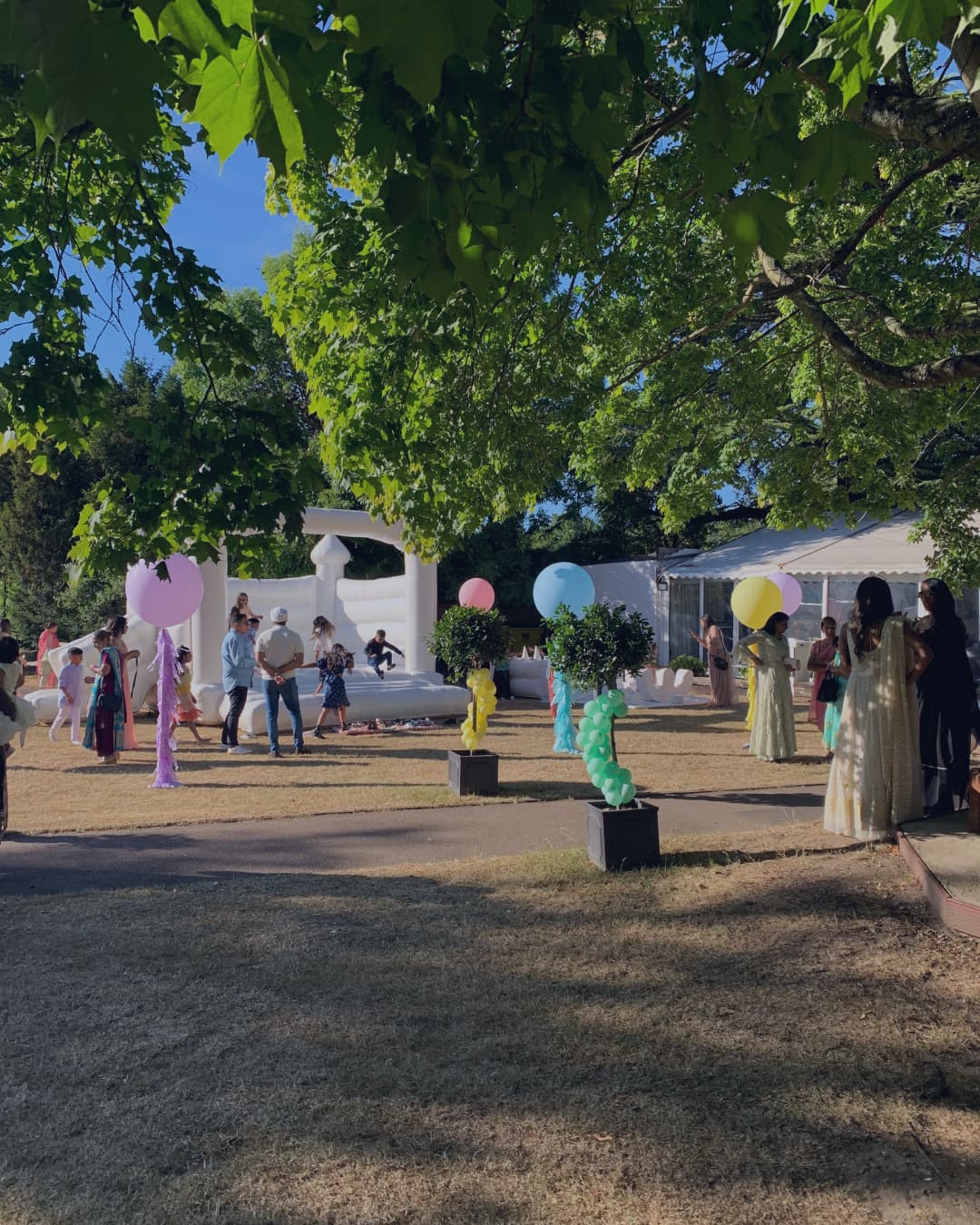 Guests gathered in the estate grounds during a summer celebration