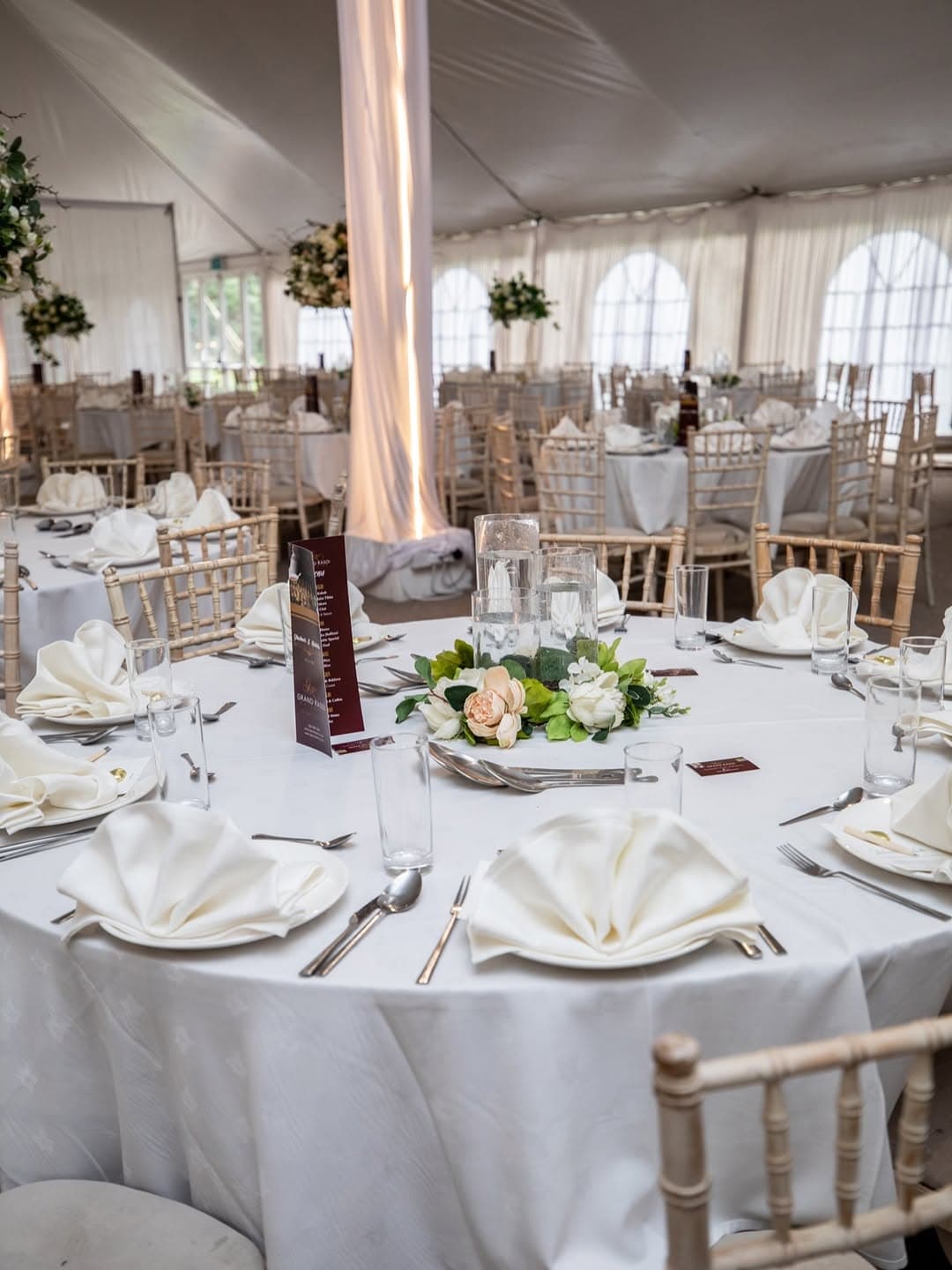 Floral details and place settings inside the marquee