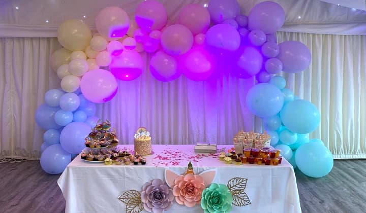 A celebration dressed with balloons and a styled dessert table